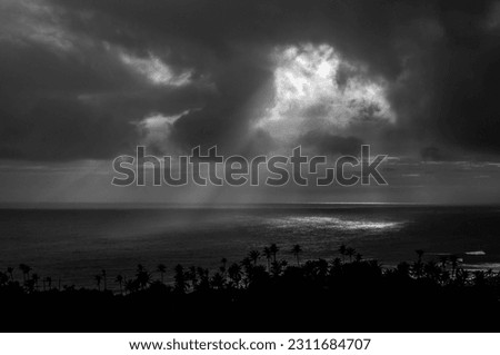 Taken this photo in University of Ruhuna. Southern coast of Sri Lanka. Black and white photo. Depicts the sun breaking through the clouds.