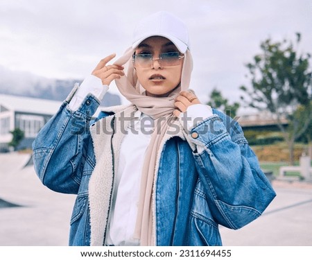 Portrait, sunglasses or religion with a muslim woman outdoor in a cap and scarf for contemporary style. Islam, fashion or hijab with a trendy young arab female person posing outside in modern clothes