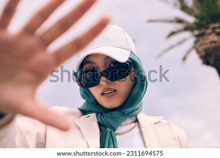 Muslim woman, fashion selfie and portrait in city, street and gen z aesthetic for beauty, blog and post. Young islamic girl, student and influencer with sunglasses, social media and travel in Dubai
