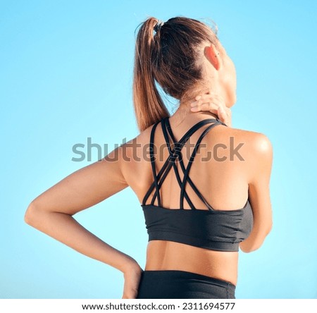 Fitness, back view of woman with neck pain and in blue sky outdoors for yoga exercise. Workout or training for health wellness, sports athlete and female person struggling with cramp in muscle Royalty-Free Stock Photo #2311694577