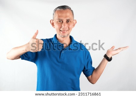 Portrait of Adult Asian Man pointing hands and finger to the side. (explain something).
