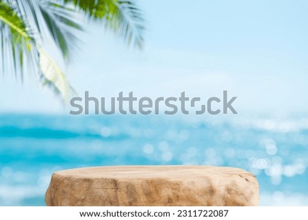 Summer product display on wooden podium at sea tropical beach Royalty-Free Stock Photo #2311722087