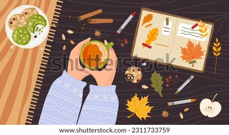 Cozy Autumn. Person Hands holding hot spicy drink. Wooden table with creative notebook, cookies, red leaves. Autumn flat lay, top view illustration for Fall mood poster, postcard, flyer template Royalty-Free Stock Photo #2311733759