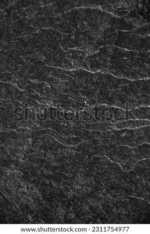 Cracked rock texture. Black white stone background. black and white highlight. Dark gray rough surface. enlargement. Background image of concrete shapes of broken, damaged, and collapsed stones