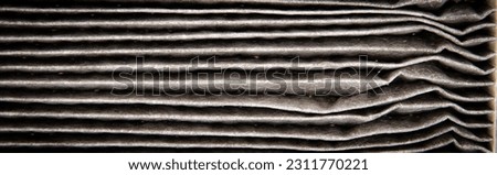 Panorama view close-up dirty car cabin air flow made of fiber paper cotton with debris clogged and polluted air filter isolated on white background. Replaced auto air filter