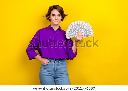 Photo of young rich investor businesswoman hold her high income usd banknotes cash big money salary isolated on yellow color background