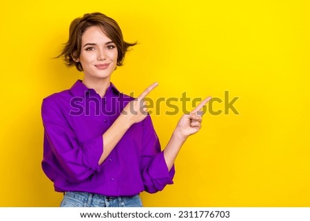 Photo of cute lady agent direct fingers empty space useful information wear violet office blouse isolated yellow color background