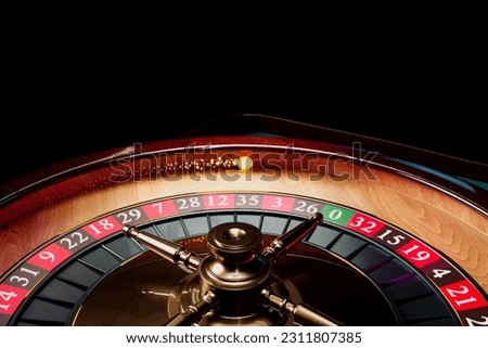 Close up shot of a spinning roulette. Presentation of a luxury casino roulette wheel with a yellow spinning fireball. Polished, elegant roulette with golden elements in Las Vegas. Gambling. Lucky game Royalty-Free Stock Photo #2311807385