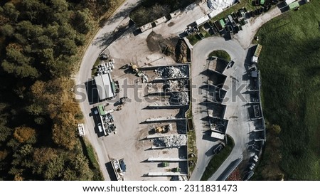 Landfill site, a pile of stinky different junk disposal in the concrete section for unsorted waste materials Royalty-Free Stock Photo #2311831473