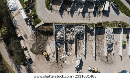 Landfill site, a pile of stinky different junk disposal in the concrete section for unsorted waste materials Royalty-Free Stock Photo #2311831483