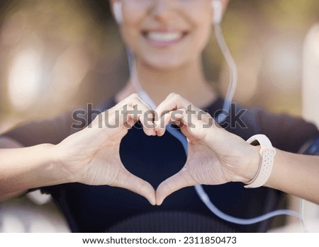 Healthy, heart hands or happy girl runner in park for fitness, exercise or workout for cardiovascular health. Love sign, hand gesture or blurry sports woman in sports training for wellness in nature Royalty-Free Stock Photo #2311850473