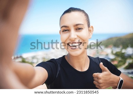 Runner woman, mountain selfie and fitness portrait with energy, smile and training for wellness on social media. Girl, influencer and profile picture with ocean, cityscape and thumbs up in summer