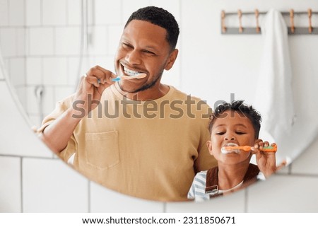 Brushing teeth, father and child in a home bathroom for dental health and wellness with smile. Face of a man and african boy kid learning to clean mouth with a toothbrush and mirror for oral hygiene Royalty-Free Stock Photo #2311850671
