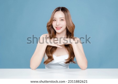 Young Asian beauty woman curly long hair with korean makeup style on face and perfect clean skin on isolated blue background. Facial treatment, Cosmetology, plastic surgery. Royalty-Free Stock Photo #2311882621