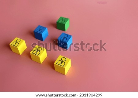Company hierarchical organizational chart using wooden cubes on pink background with copy space. 