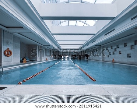 Luxury indoor swimming pool, part of luxury hotel.Inside, there is plenty of sunshine. Royalty-Free Stock Photo #2311915421