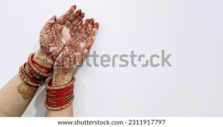 A Beautiful Indian female hands with henna tattoo isolated on white background