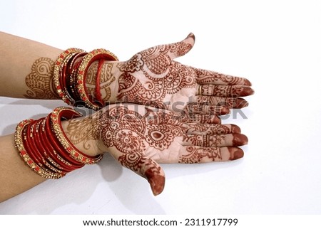 A Beautiful Indian female hands with henna tattoo isolated on white background Royalty-Free Stock Photo #2311917799
