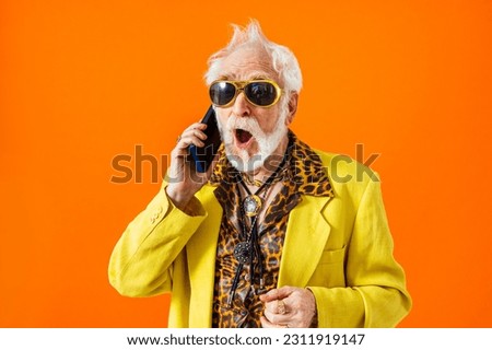 Cool senior man with fashionable clothing style portrait on colored background - Funny old male pensioner with eccentric style having fun