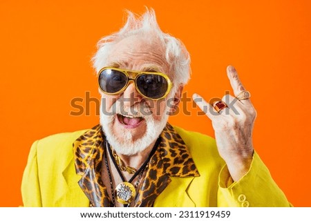 Cool senior man with fashionable clothing style portrait on colored background - Funny old male pensioner with eccentric style having fun