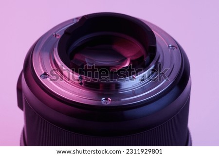 camera lens closeup isolated on white background in pink lilac neon light