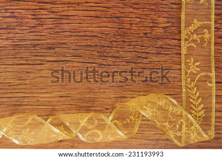 golden ribbon frame  on wood  background