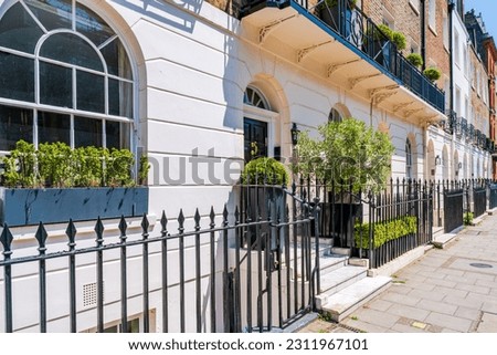 Elegant terraced houses in residential street of Belgravia, London, UK Royalty-Free Stock Photo #2311967101