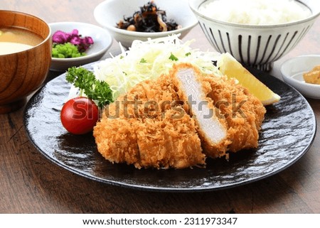 Tonkatsu set meal served at the dining table with a small bowl Royalty-Free Stock Photo #2311973347