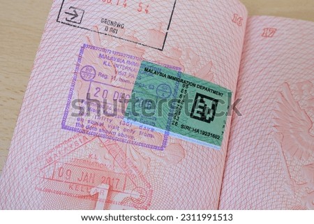 close up part of pages of foreign passport with foreign sri lanka visa, border stamps, permits to enter countries, concept of traveling around the world, traveler's travel document