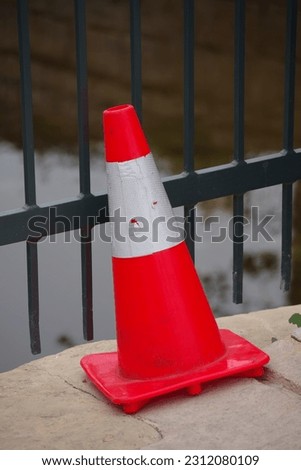 Traffic cone at a bridge railing