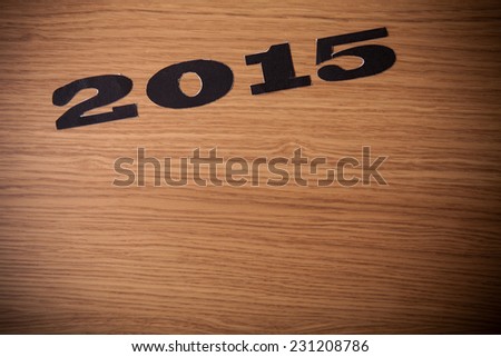 Inscription 2015 on flour on a wooden table
