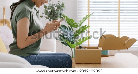 Young asia people happy girl smile unbox open gift buy order from online store shop take photo shoot camera post social media IG reel app show youth lifestyle blog share sit relax at home sofa couch.