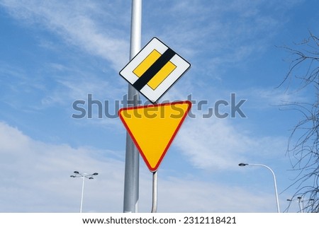 D-2 end of priority road sign and A-7 yield or give way sign. Road signs in Poland.