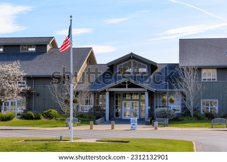 American flag flies outside ballot drop at local government building Royalty-Free Stock Photo #2312132901