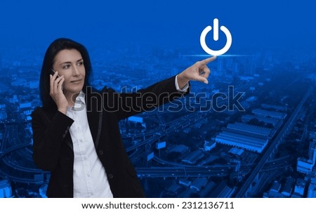 Businesswoman hand pressing power button icon over modern city tower, street, expressway and skyscraper, Start up business concept