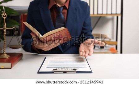 Male lawyer working with law book, A legal binding, Unilateral contract, Multilateral, Non-reciprocal contract, Default, Obligation, Power of attorney, Defense of a prescription, Court decree Royalty-Free Stock Photo #2312145943