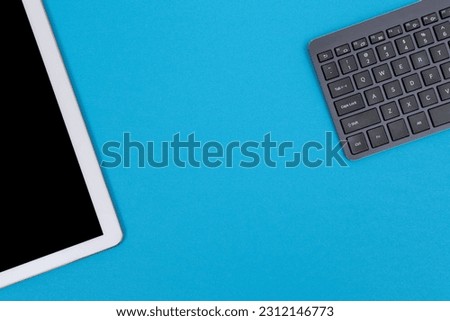 Office Workplace with Digital Gadgets Lying on Blue Table - Flat Lay