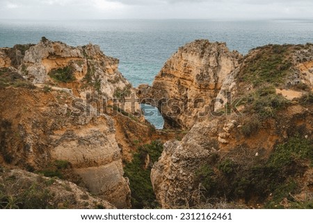 Famous tourist destination of Ponta da Piedade on the southern peninsula of Lagos in the Algarve region of Portugal. Cape of yellow-gold cliffs during the afternoon.