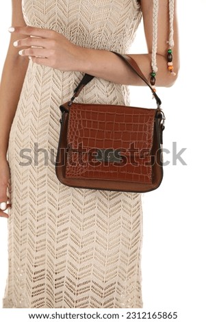 new brown women's handbag. fashion shoot in the studio