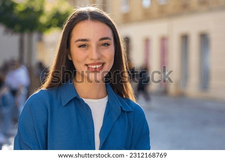 Close-up portrait of happy young woman face smiling friendly, glad expression looking at camera dreaming, resting, relaxation feel satisfied good news outdoors. Pretty girl in urban city sunny street Royalty-Free Stock Photo #2312168769