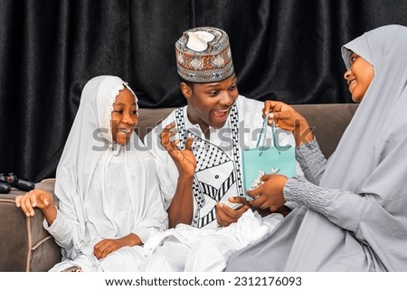Excited African Muslim family celebrating together Royalty-Free Stock Photo #2312176093