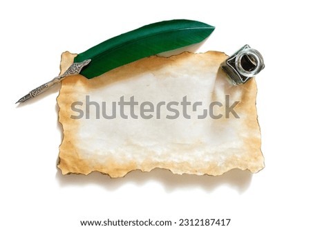 Quill pen and ink well resting on blank parchment paper isolated background with copy space for message Royalty-Free Stock Photo #2312187417