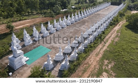 Many white Buddha statues Wat Phra Phutthabat Nam Thip is located on the Phu Phan mountain range.Sakon Nakhon Province,Thailand:Use for website banner background,backdrop