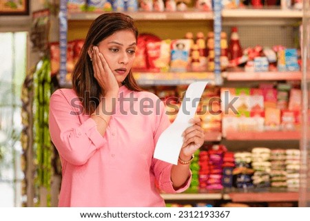 Indian woman panic from inflation. shocking reaction after watching bills. Royalty-Free Stock Photo #2312193367