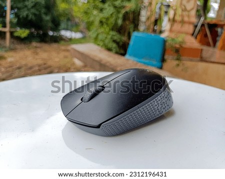 taking pictures of wireless mouse on the porch of the house