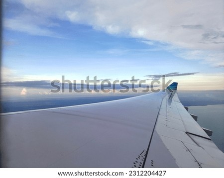 a plane wing view in sky, so we can make it background or take a note to picture, like "dream high" or anything else