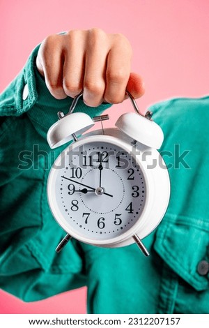 White alarm clock in male hand. Early morning, 9 o clock correct day routine, living in moment, appreciate every minute of life, youth. High quality
