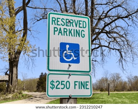 A close view of the metal handicap sign.