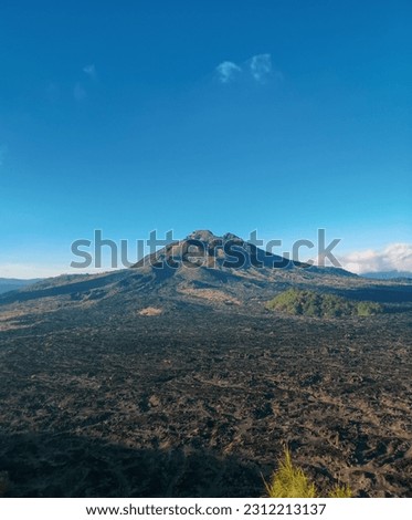 View of Mount Batur with black lava below. Mount Batur located at Kintamani, Bali
