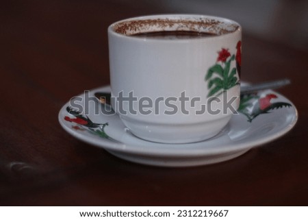 black coffee in a white mug on a wooden table